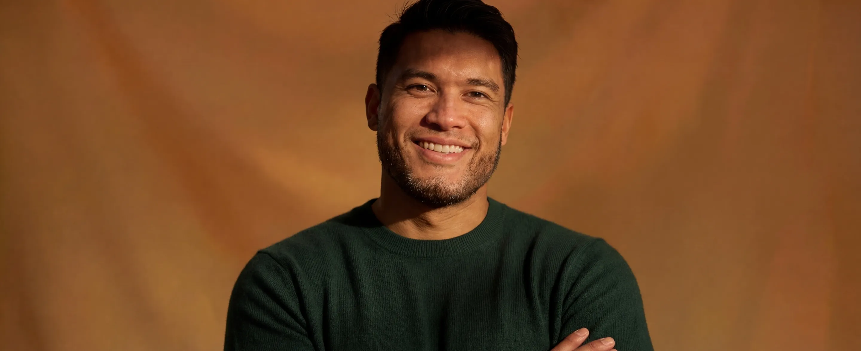 Man smiling, centered, primary color background
